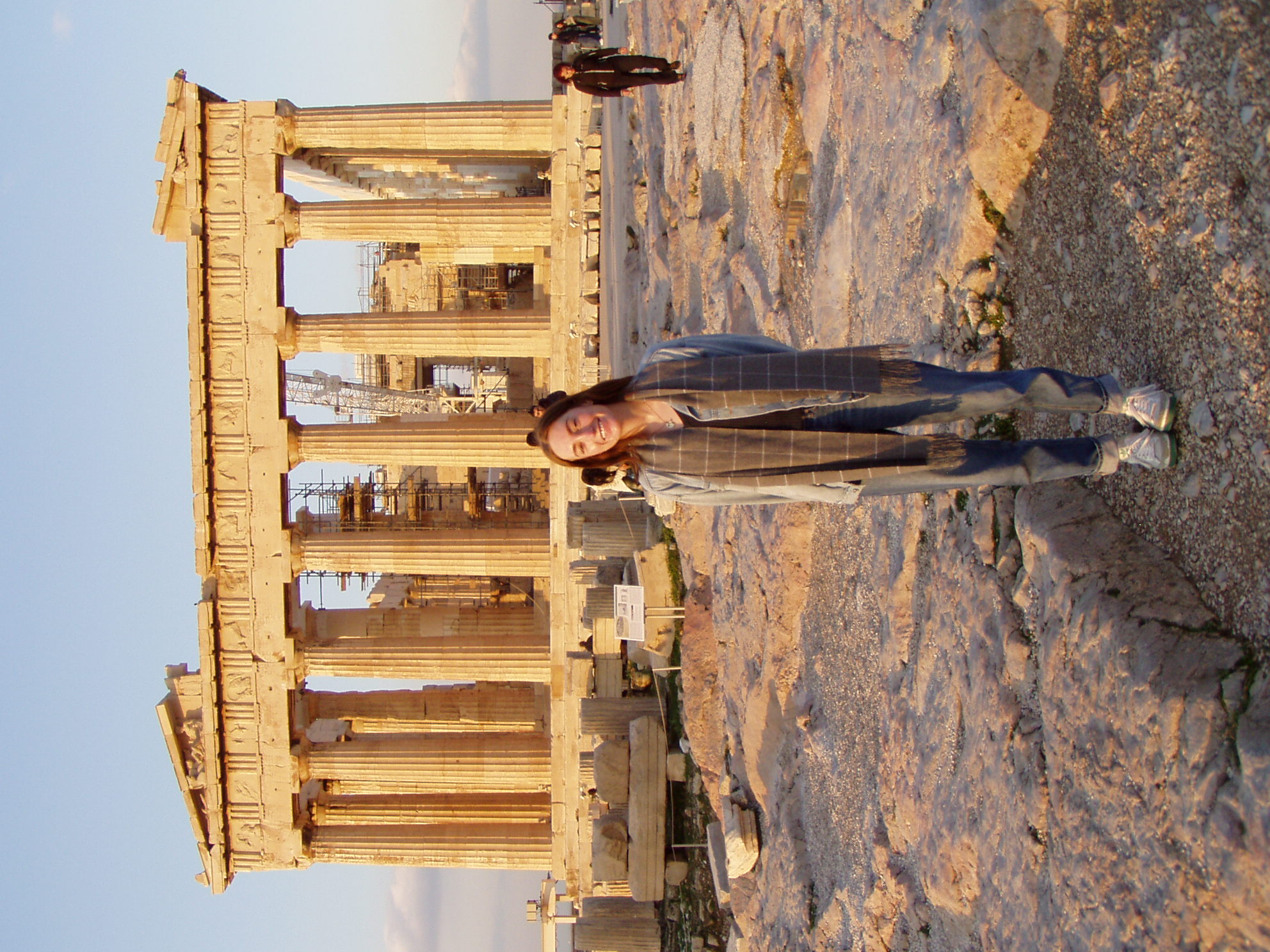 A woman standing in front of the Acropolis in Greece